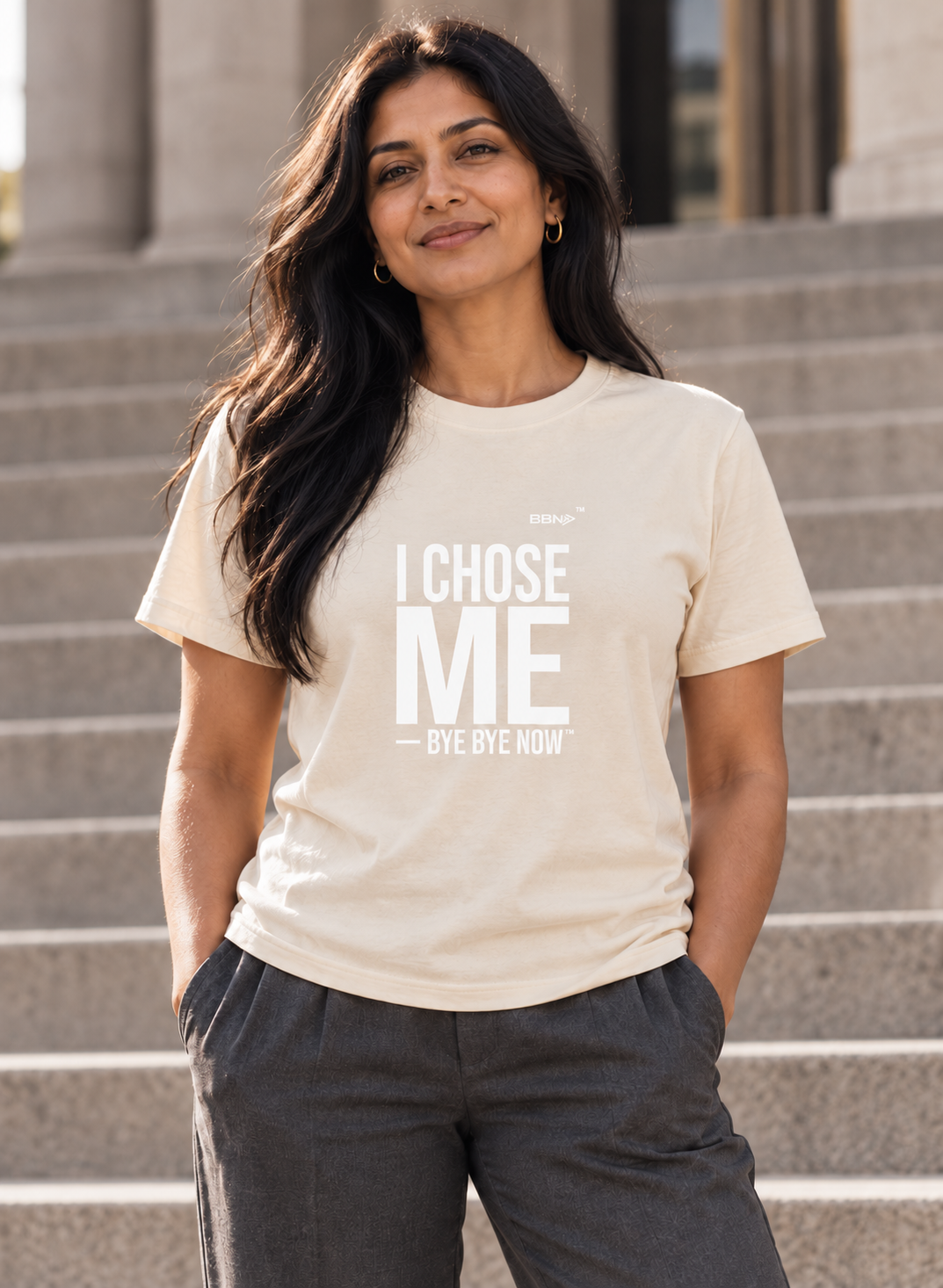 AI styling concept: Woman outdoors wearing a natural cream T-shirt with bold white “I Chose Me” lettering and white “Bye Bye Now”.