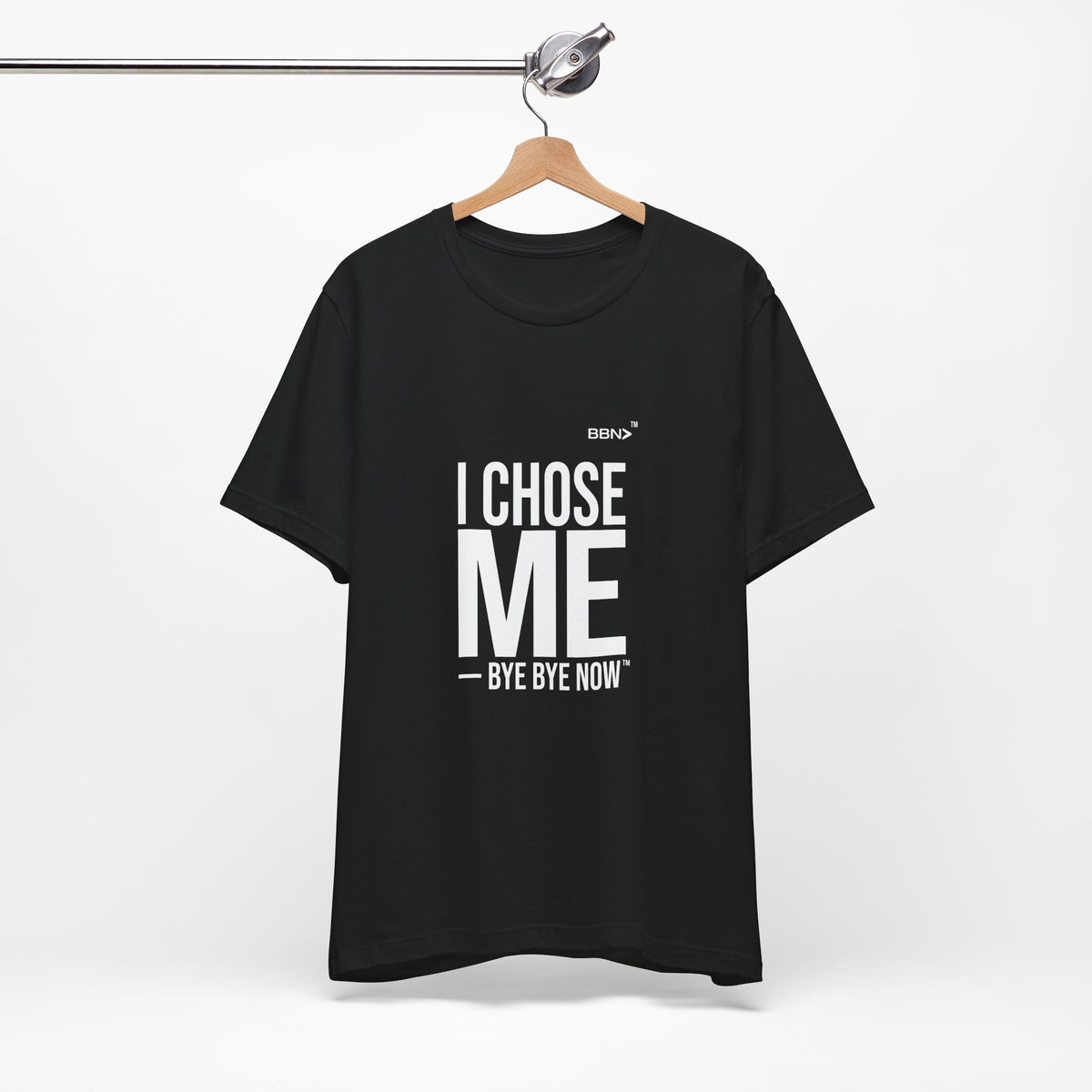 I Chose Me Tee in black on a wooden hanger, showing the front print.