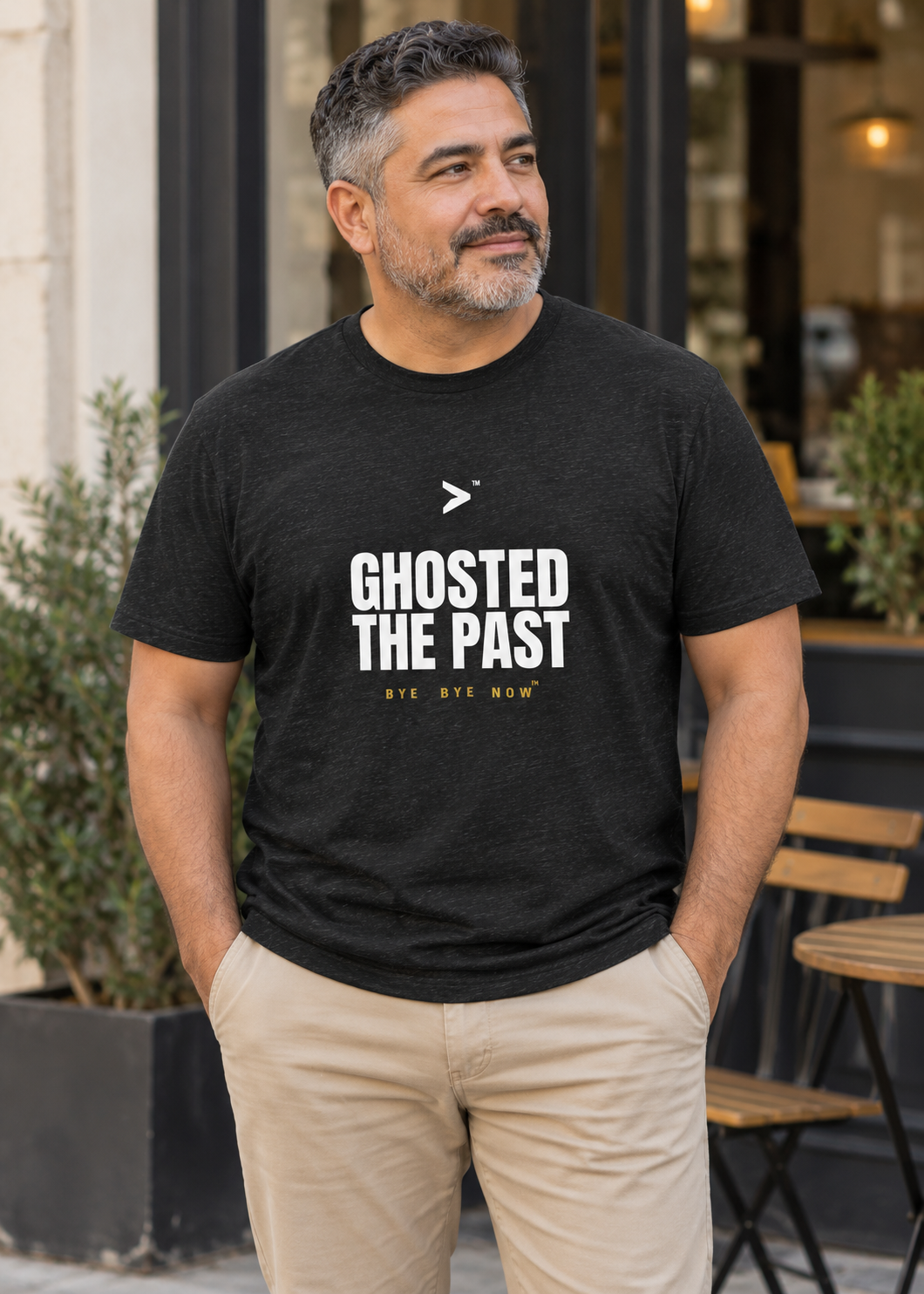 AI styling concept: Man outdoors wearing a black heather T-shirt with bold white “Ghosted the Past” lettering and gold “Bye Bye Now”.