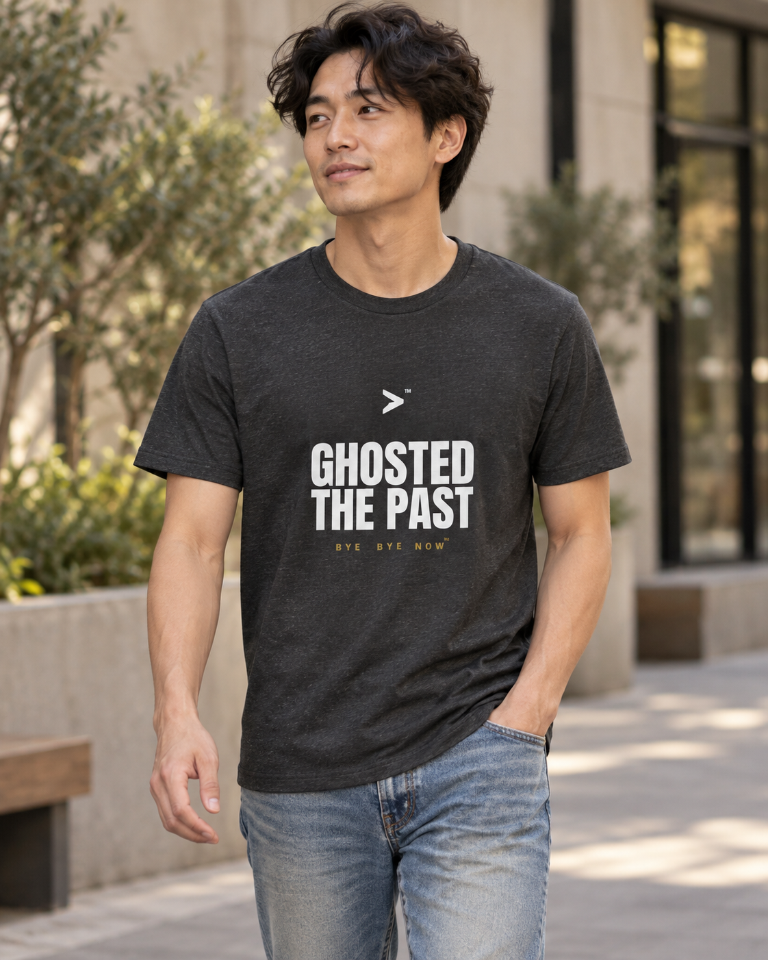 AI styling concept: Man outdoors wearing a dark gray heather T-shirt with bold white “Ghosted the Past” lettering and gold “Bye Bye Now”.