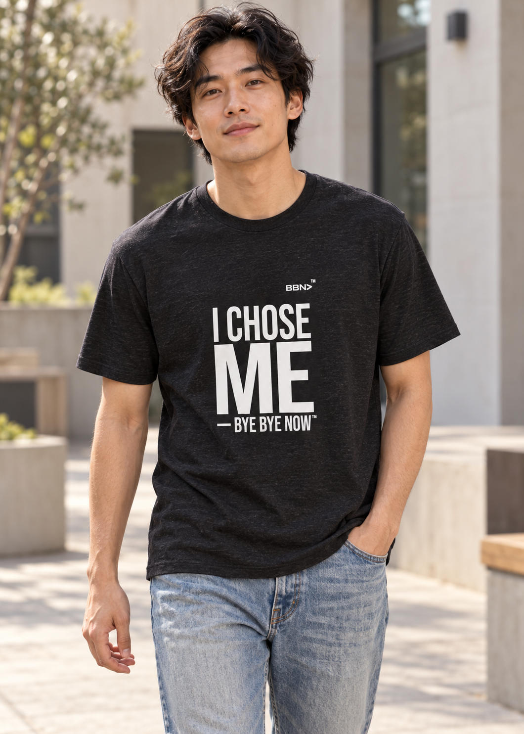 AI styling concept: Man outdoors wearing a black heather T-shirt with bold white “I Chose Me” lettering and white “Bye Bye Now”.