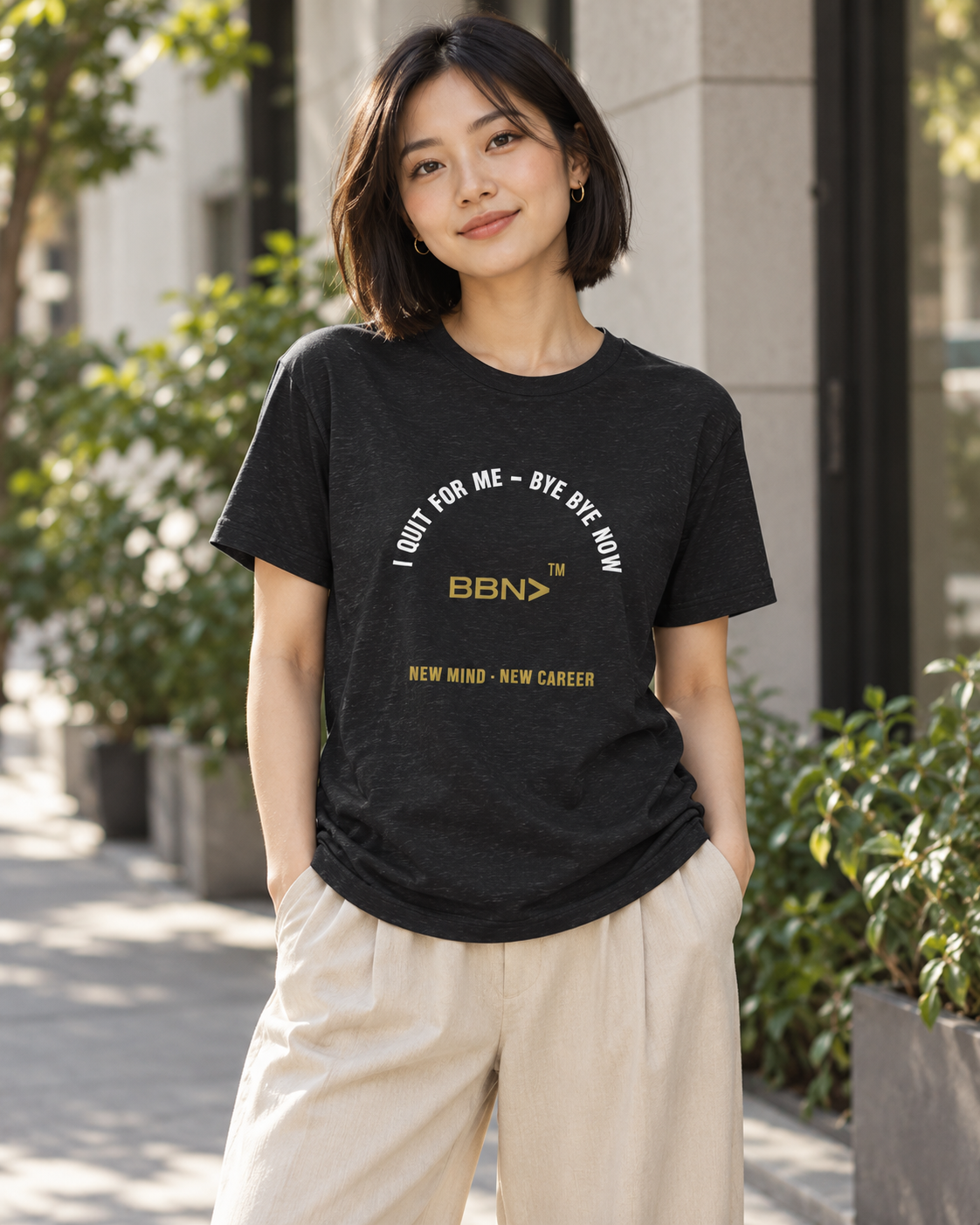 AI styling concept: Woman outdoors wearing a black heather T-shirt with white “I Quit For Me – Bye Bye Now” lettering and a gold BBN logo.