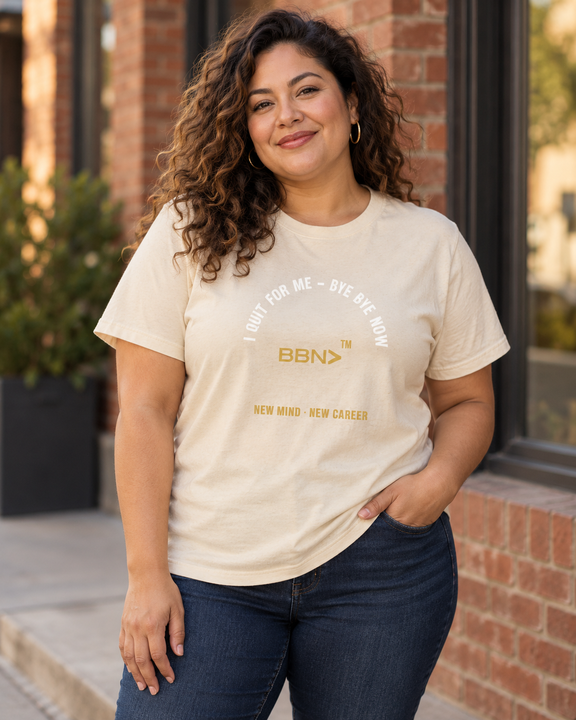 AI styling concept: Woman outdoors wearing a natural cream T-shirt with white “I Quit For Me – Bye Bye Now” lettering and a gold BBN logo.