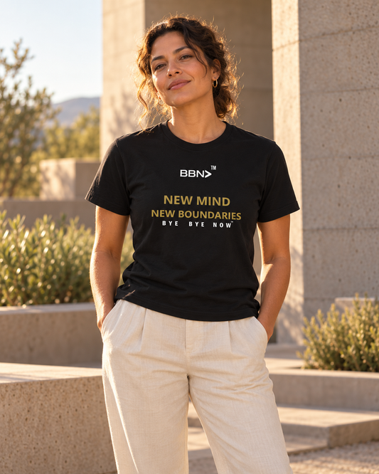 AI styling concept: Woman outdoors wearing a black T-shirt with gold “New Mind New Boundaries” lettering and a white BBN logo.